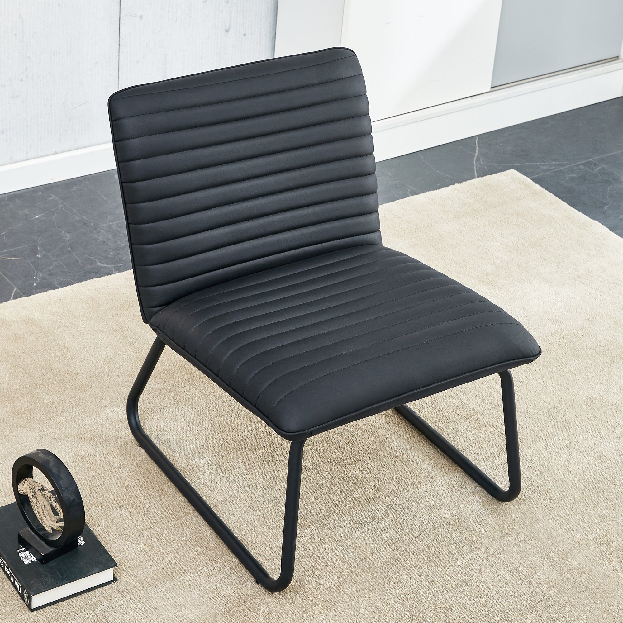 Black minimalist armless sofa chair with PU backrest paired with black metal legs