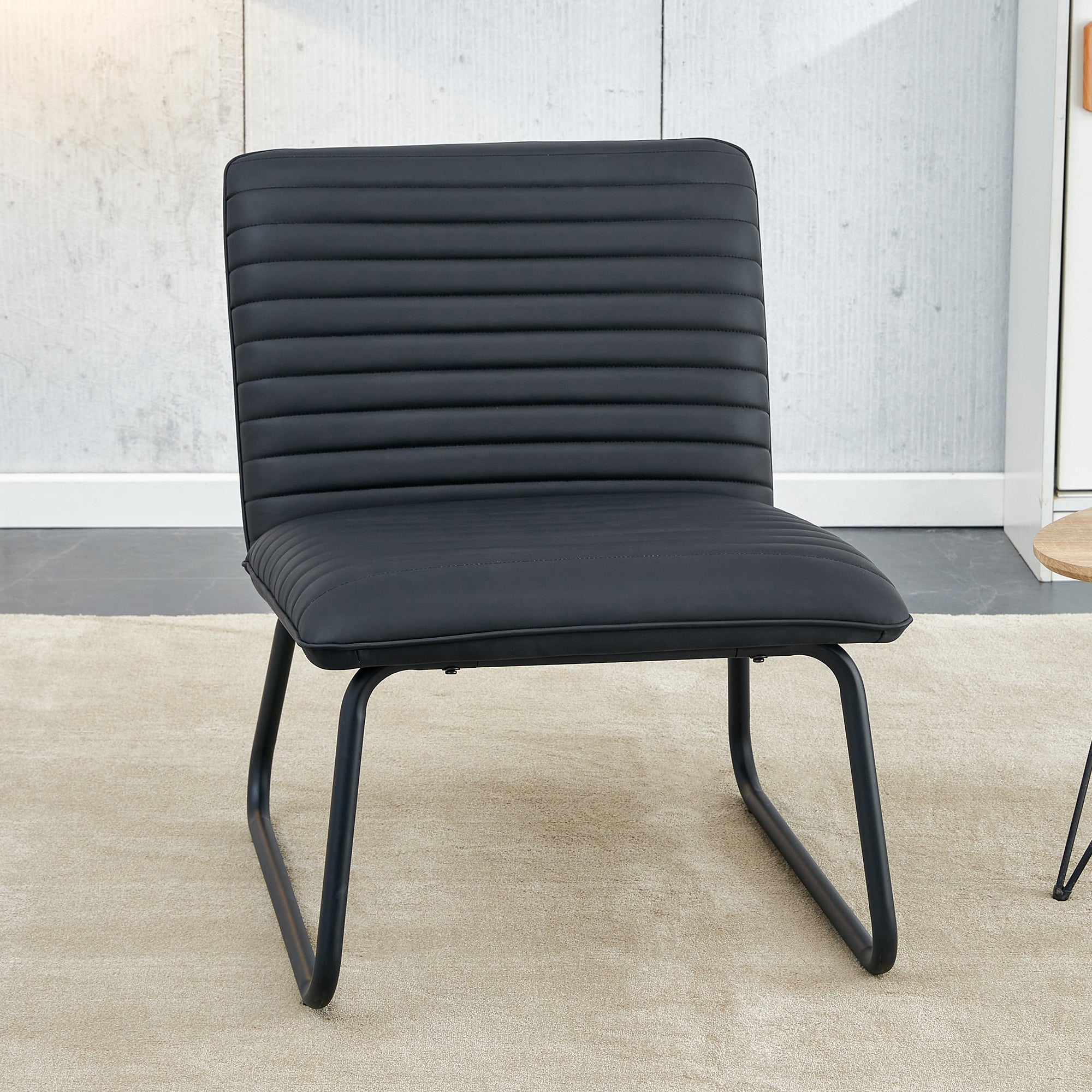 Black minimalist armless sofa chair with PU backrest paired with black metal legs