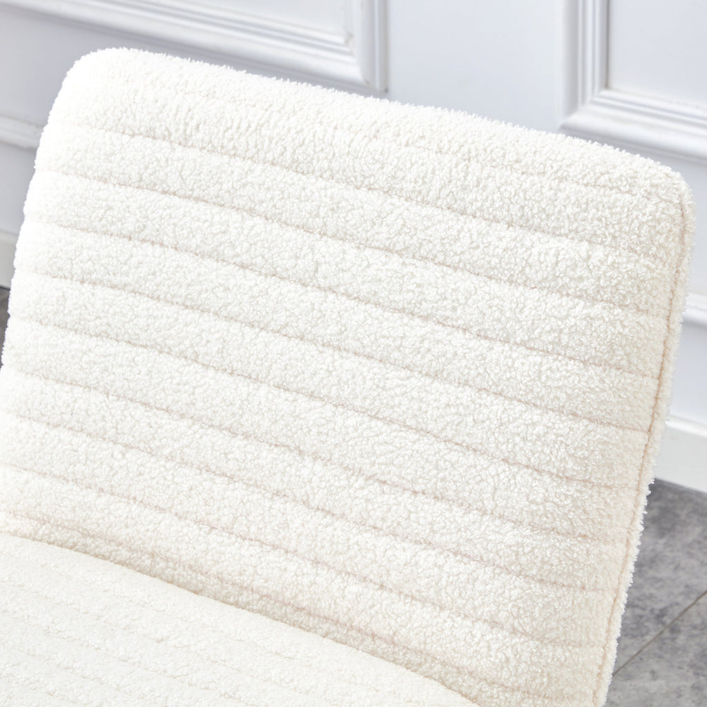 One White minimalist armless sofa chair with plush cushion and backrest paired with golden metal legs